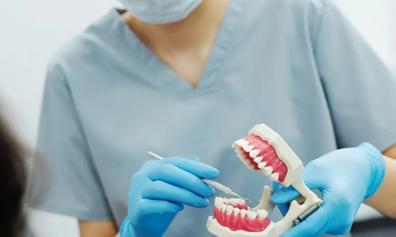 Dentist gently consulting a relaxed patient before sleep dentistry sedation procedure at Deekshu Dental Implant Center Sarjapura Bangalore