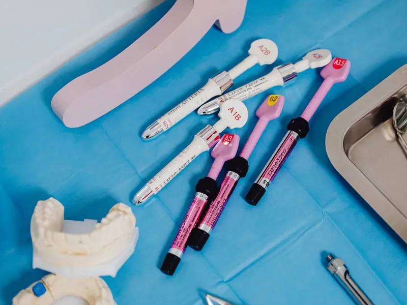 Dental instruments and composite bonding materials on a sterile surface used for teeth gap closure treatment at Sarjapura clinic