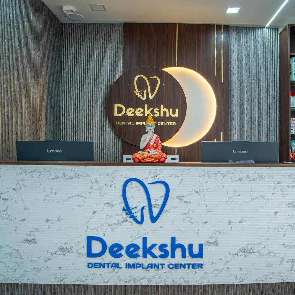 Patient coordinator at the front desk of a modern dental clinic managing appointments at Deekshu Dental, Sarjapura, Bangalore
